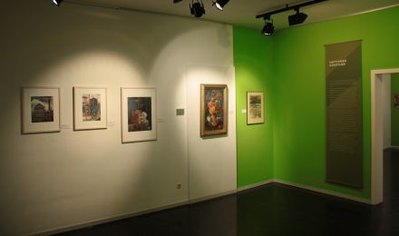Ausstellungsraum: Wand mit Bildern.