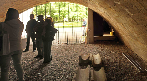 Im Lapidarium unter der Inneren Brücke: Unter einem niedrigen Gewölbe stehen eine Besuchergruppe.
